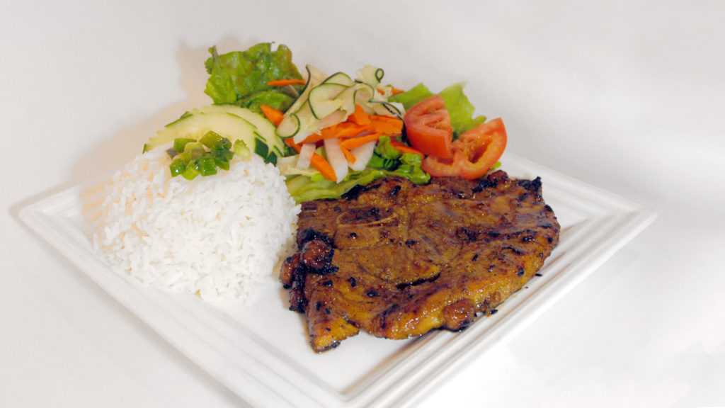rice with grilled pork chop and a side of salad